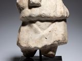 an image of a stone sculpture of a man holding a book