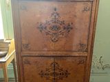 a wooden cabinet that is sitting on a wooden floor