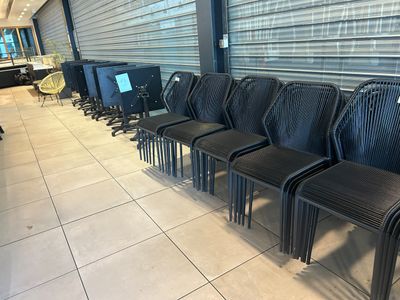 many chairs lined up in a row in front of a window