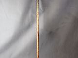 a close up of a cane with a wooden handle on a white background