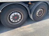a truck with a flat tire parked on the street