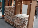several stacks of wood stacked on top of each other in a warehouse