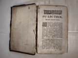 an old book that is open on a table
