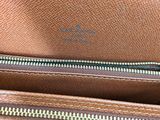 the inside of a brown leather purse with zippers on it