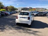 a white car parked in a parking lot next to other cars