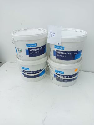 three buckets of paint sitting on top of a white table