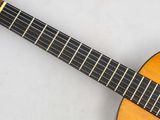 a close up of a guitar on a white surface