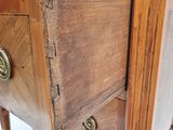 a close up of a wooden cabinet with a marble top