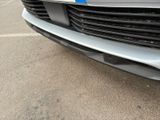a close up of the front of a car with a blue stripe on it