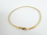 a gold bracelet with a snake clasp on a white background