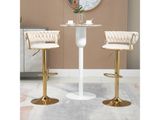 deux tabourets de bar blancs et dorés placés à côté d'une table ronde