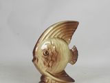 a figurine of a fish on a white background