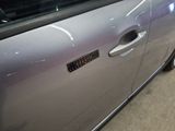 a close up of a car door with a sticker on it