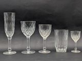 six wine glasses and a wine glass are lined up on a table