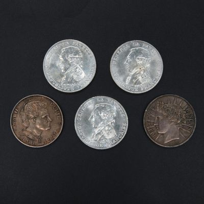 four different types of coins sitting on top of a black surface