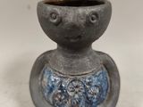 a small gray vase with a blue design on it