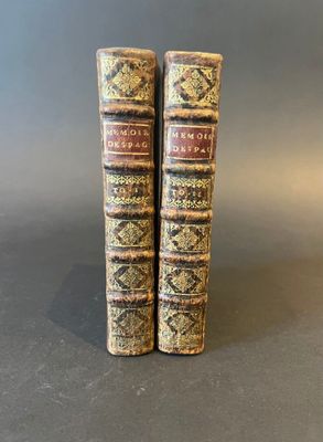 a pair of books sitting on top of each other on a table