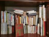 a book shelf with many books on it in a room