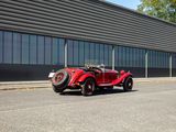 a red car that is parked in front of a building