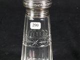 a glass salt and pepper shaker on a black background