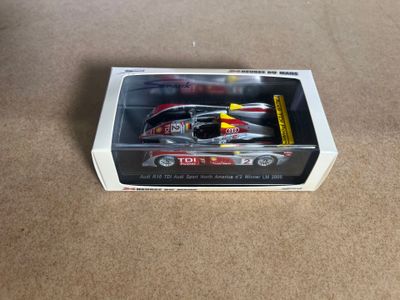 a toy car that is in a box on the floor