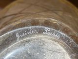 a close up of a silver vase with writing on it