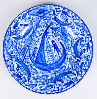 a blue and white plate with an image of a boat on it