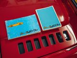 two books on the hood of a red car