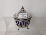 a silver and blue glass box with a label on it