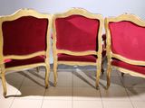 three red chairs sitting next to each other on a tiled floor