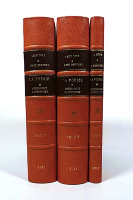 three red books sitting on top of each other on a white surface