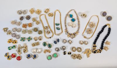 a collection of costume jewelry including brooches, bracelets, earrings, and rings