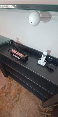 a table with a cell phone and a charger on it