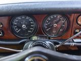 steering wheel of a car with a speedometer, gauges, and other instruments