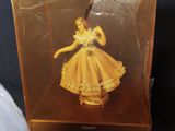 disney princess figurine in a clear box holding a knife