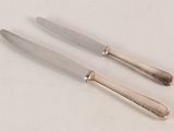 two knives that are sitting next to each other on a table