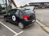 une petite voiture noire garée sur un parking