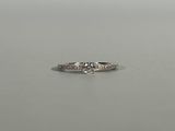 a close up of a diamond ring on a table