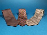 three different colored neck ties on a blue background