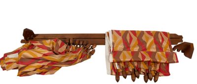 a scarf hanging on a rack with a knife in it
