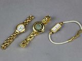 two watches and a bracelet are sitting on a table