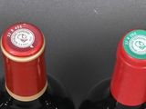 four bottles of wine are lined up in a row on a table