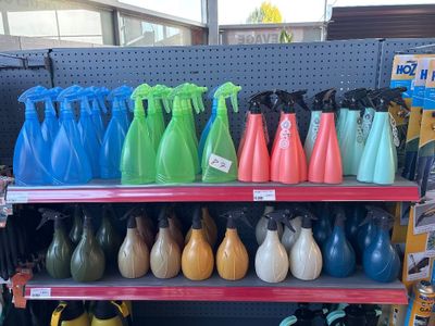 many different colored vases on the shelves in the store
