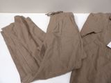 brown pants on a white table with a tag on it