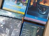 several blu - ray movies are in a cardboard box on a table