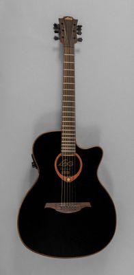 an image of a black acoustic guitar hanging on a wall