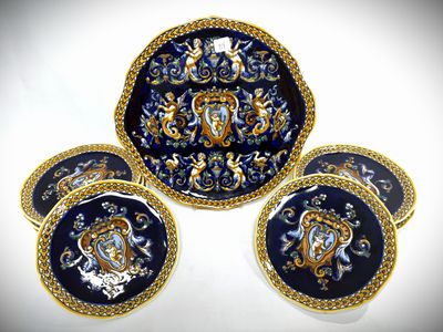 four blue and gold plates with gold trims and designs on them