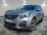 une voiture argentée est garée dans une pièce au sol en damier