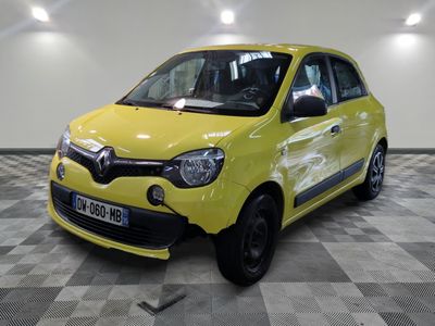 La petite voiture jaune est garée sur le sol à damier.