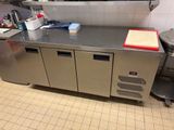 a kitchen with stainless steel counter tops and a metal cabinet